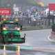 A sweeper truck tries to clear rain from the race track in Belgium